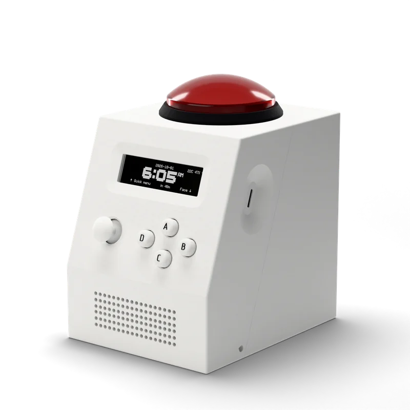 CinderClock seen from the left: white body, red 100 mm arcade-button dome on top, wide display aperture on the raked control face